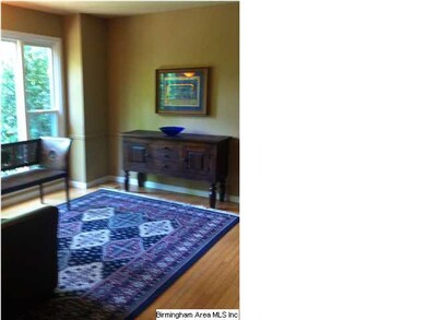 Living room with hardwood floors has double openin