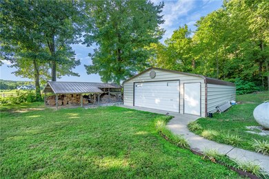 1000 sqft heated and cooled shop and covered wood shed!