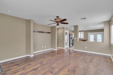 Unfurnished living room featuring wood finished floors, ceiling fan, recessed lighting, and french doors