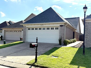 View of front of home with driveway, a garage, a shingled roof, a front lawn, and brick siding