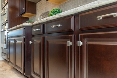 This kitchen features rich, dark wooden cabinets w