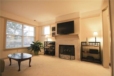 The cozy wood-burning fireplace with its tile surround and mantel shelf is the focal point of the living room area. Beautiful craftsman style wood molding frames and accentuates the room.  