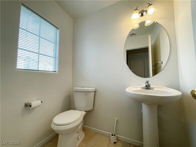 Bathroom featuring toilet, baseboards, tile patter