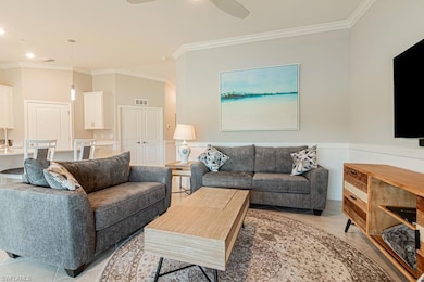 Living room featuring crown molding, ceiling fan, light tile patterned floors, and recessed lighting