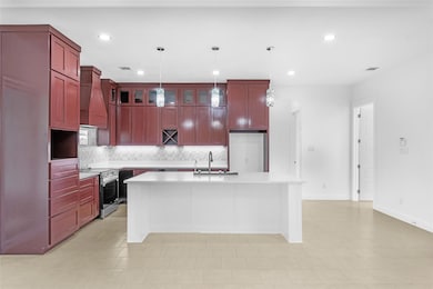 Kitchen with dark brown cabinets, a sink, stainles