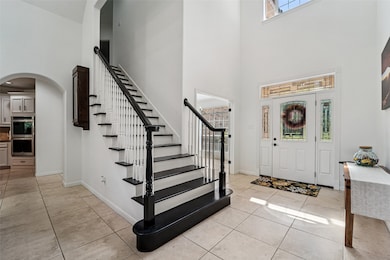 Soaring 22-foot ceilings greet you in the entry an