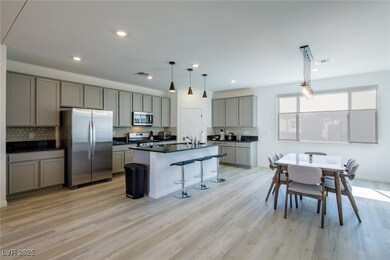 Kitchen with stainless steel appliances, gray cabi