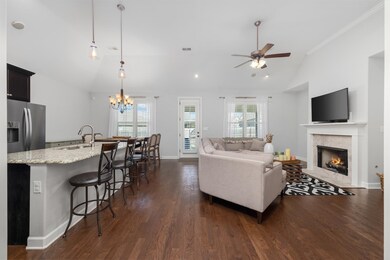 Living room with ceiling fan with notable chandeli