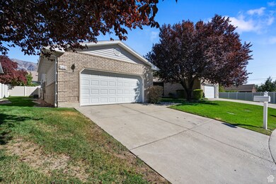 View of side of home featuring concrete driveway and brick siding