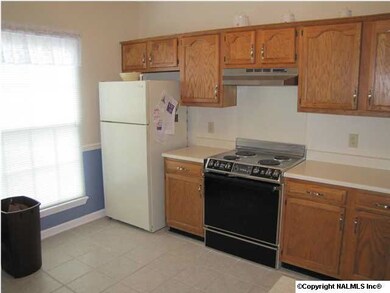 Kitchen, tile, disposal, dishwasher, range/oven,fridge,chair rail, pantry, counter has a bar for additional seating.