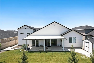 Back of property with a patio and a shed