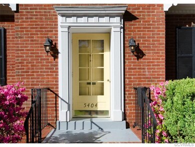 The front entry is welcoming, with a well-trimmed 