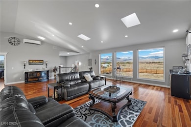 Living area featuring baseboards, a wall unit AC,