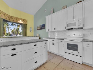 Kitchen with lofted ceiling, decorative light fixt