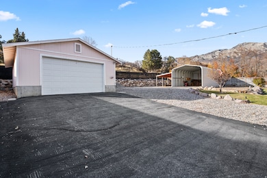 Detached garage with a mountain view and driveway