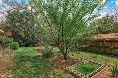 View of yard featuring a garden and fence