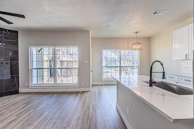 Kitchen with visible vents, light wood-style floor