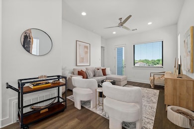 Living room with dark wood-type flooring, ceiling