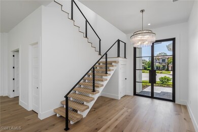 Foyer entrance featuring stairs, wood finished flo