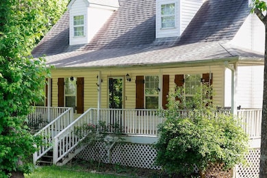 View of front facade with a porch and a shingled roof