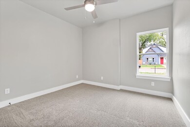 Unfurnished room featuring ceiling fan and carpet 