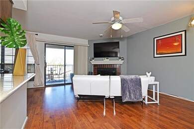 Living room with wood burning brick fireplace. Mak