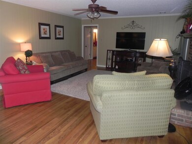 Spacious room offers hardwoods, masonry fireplace 