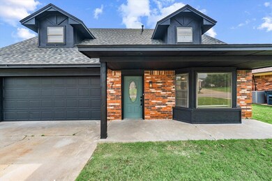 View of front of home with roof with shingles, brick siding, and concrete driveway
