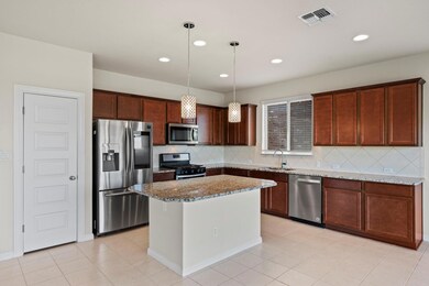 Kitchen featuring stainless steel appliances, a s