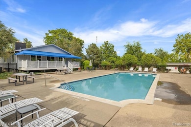 Community pool with a patio