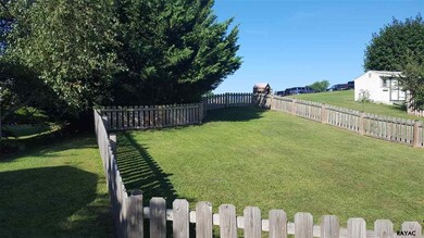 fenced rear yard with two gates