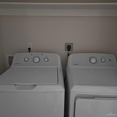 Washroom featuring washing machine and dryer and laundry area