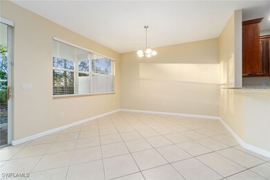 Unfurnished dining area featuring a chandelier and light tile patterned floors