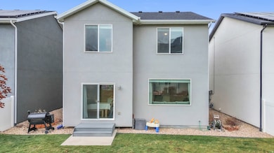 Rear view of house featuring stucco siding