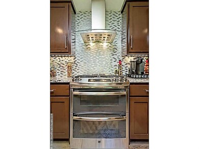 Kitchen. glass and metal tile backsplash bring light into this great space
