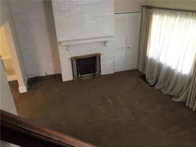 Spacious living room with decorative fireplace