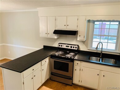 Kitchen with leathered granite countertops and sta
