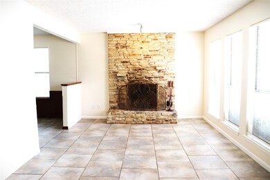 Unfurnished living room featuring tile patterned 