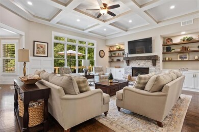 Spacious living room features abundant natural light and a stunning fireplace.