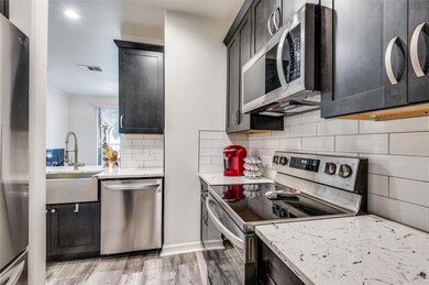 Kitchen with light quartz counters, SS farm sink, 