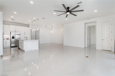 Unfurnished living room featuring a ceiling fan, r