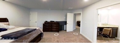 Bedroom featuring light carpet