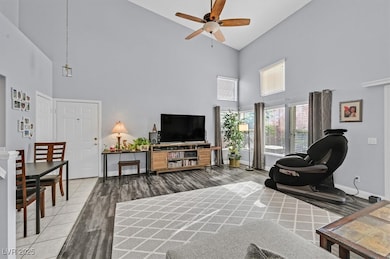 Living area with baseboards, wood finished floors,