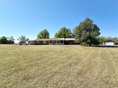 Single story home with a front yard and a garage