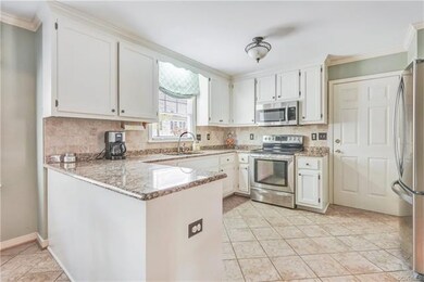 Kitchen with granite countertops and white cabinet