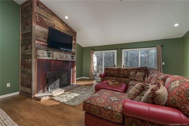 Gas fireplace with barn siding & huge beam mantle