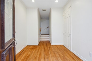 A warm welcome begins with a hardwood-clad foyer a