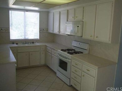 KITCHEN AND EATING AREA WHICH LEADS TO SLIDER DOOR