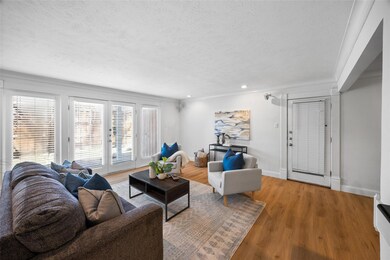 Living area with baseboards, light wood-style floo