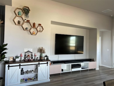 Living area with wood finished floors and baseboa